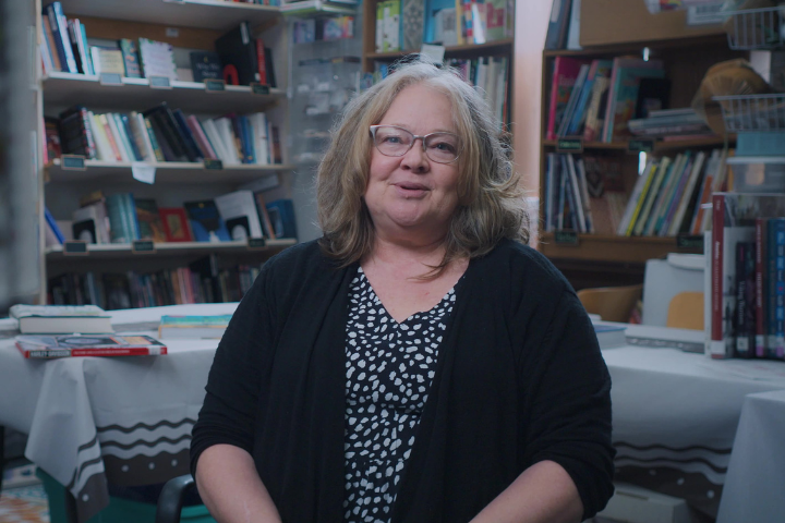 A bookstore owner in Newark, Ohio, sits in her store. 