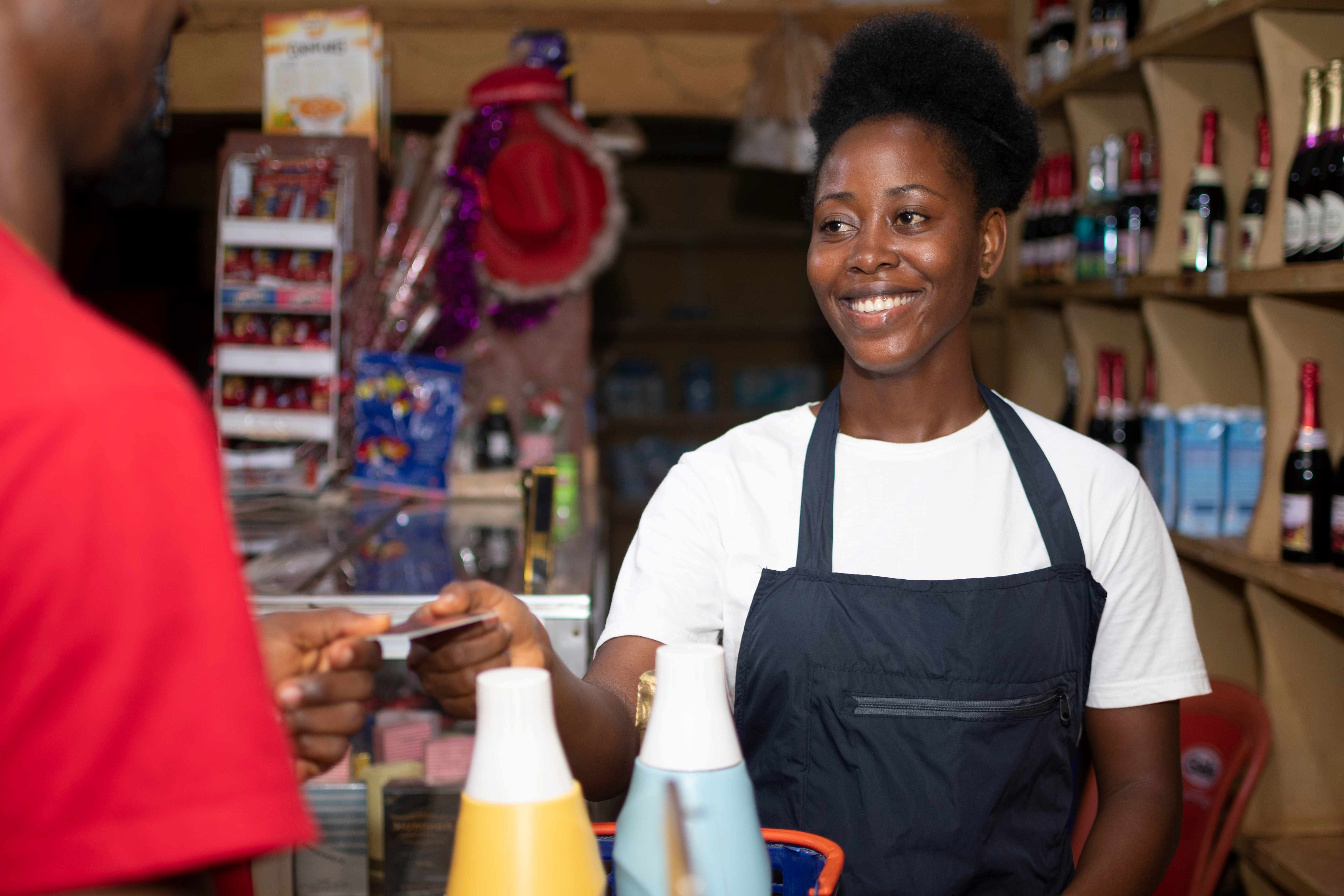 A woman in an apron at a counter. 