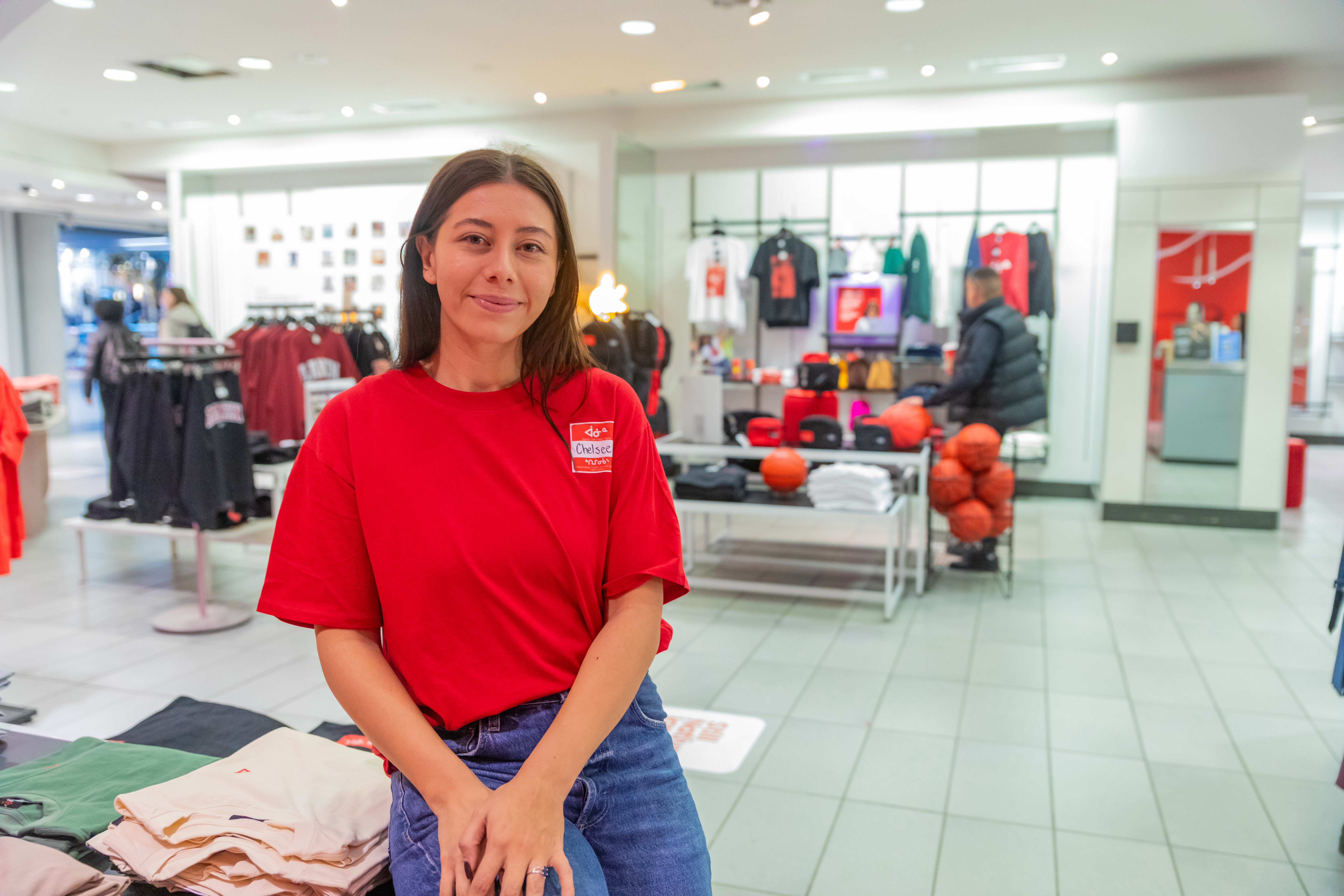 Chelsee Pettit perches on a display in her department store, Aaniin. 