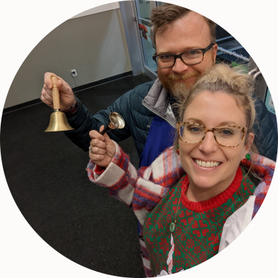 Patty and Wes Baker, wearing winter clothes, ring bells.