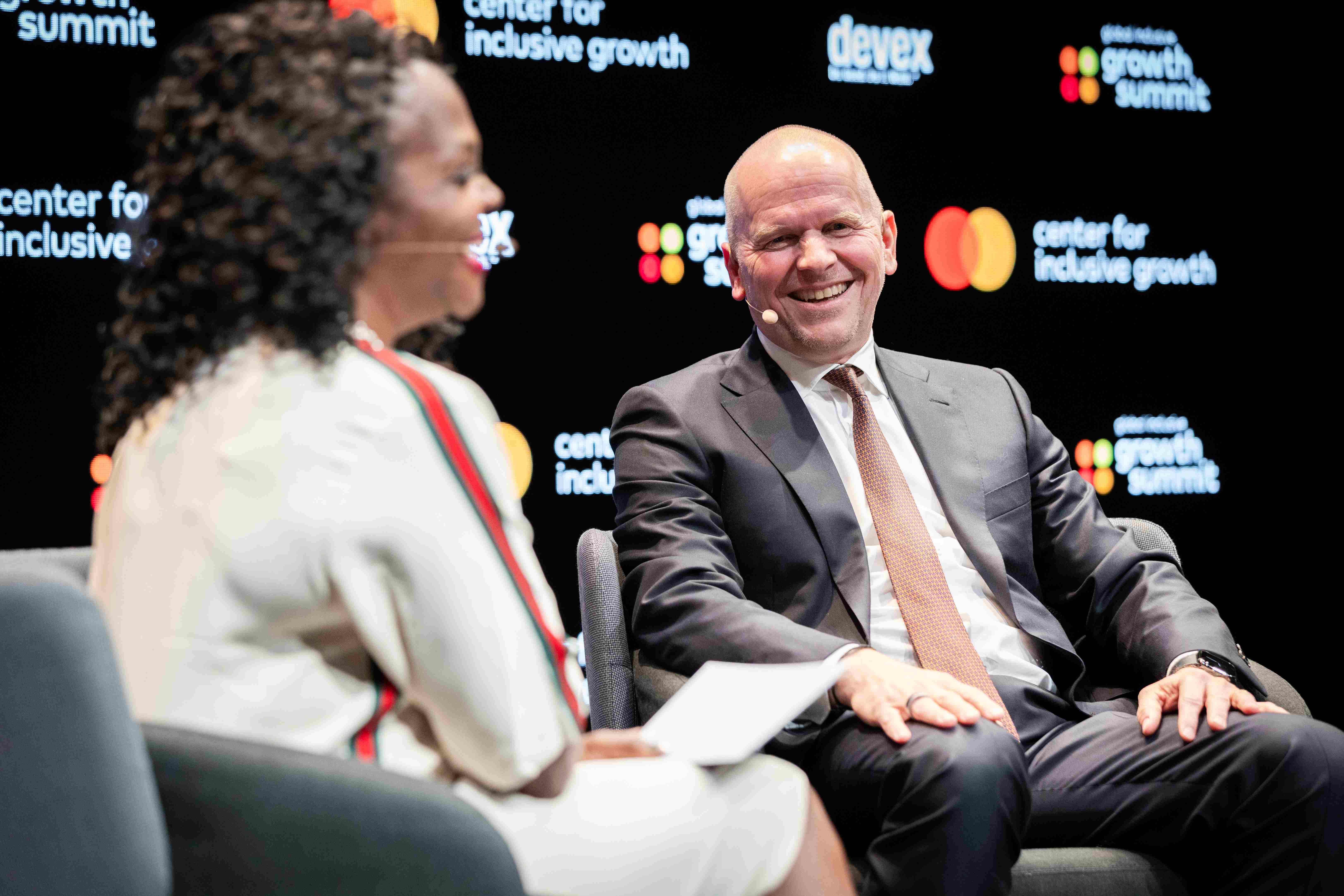 Alissa "Dr. Jay" Abdulla and Michael Miebach laugh together during a panel on cybersecurity.