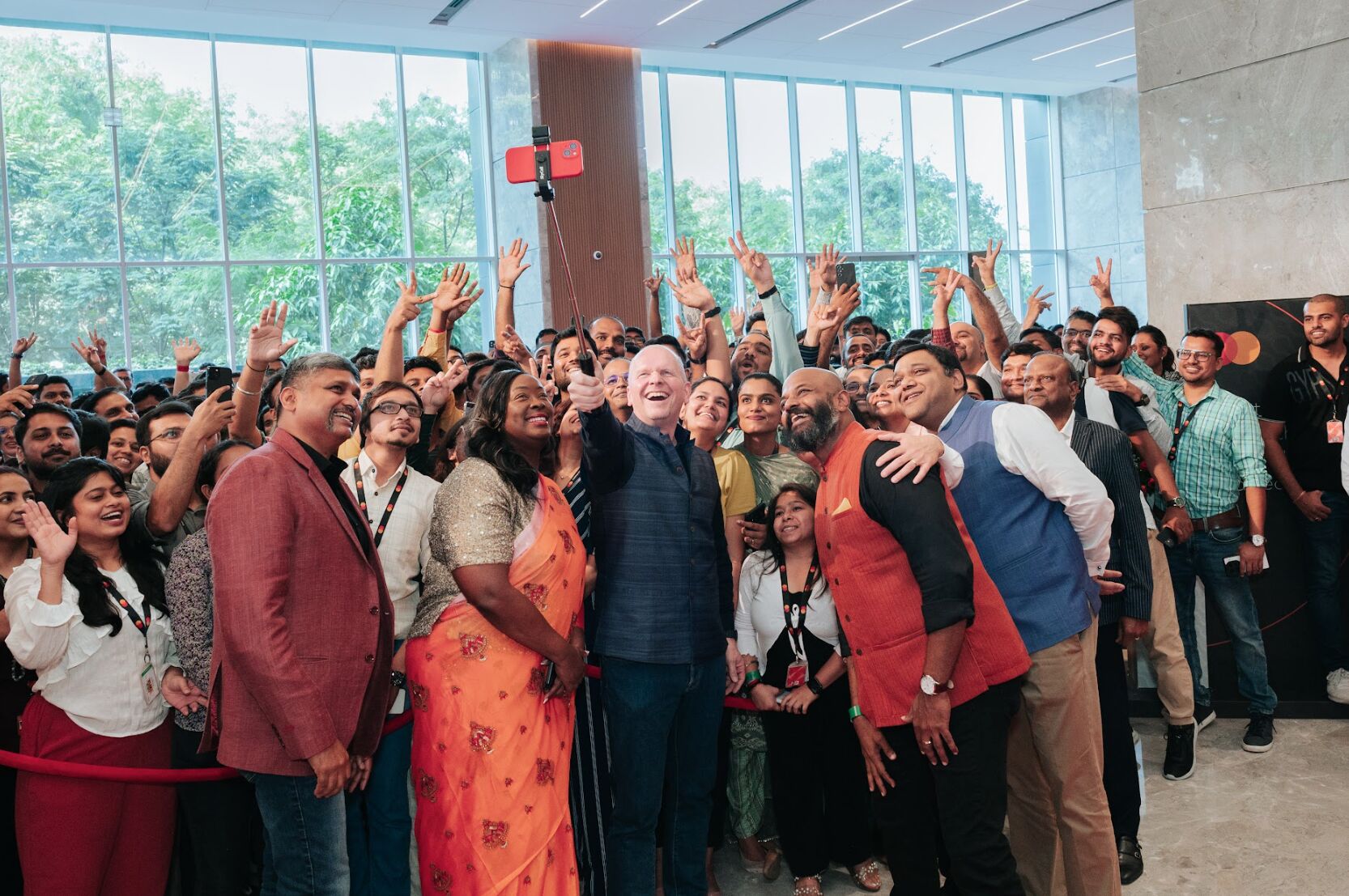 Mastercard CEO Michael Miebach captures a selfie with employees at the new Pune Tech Hub. 