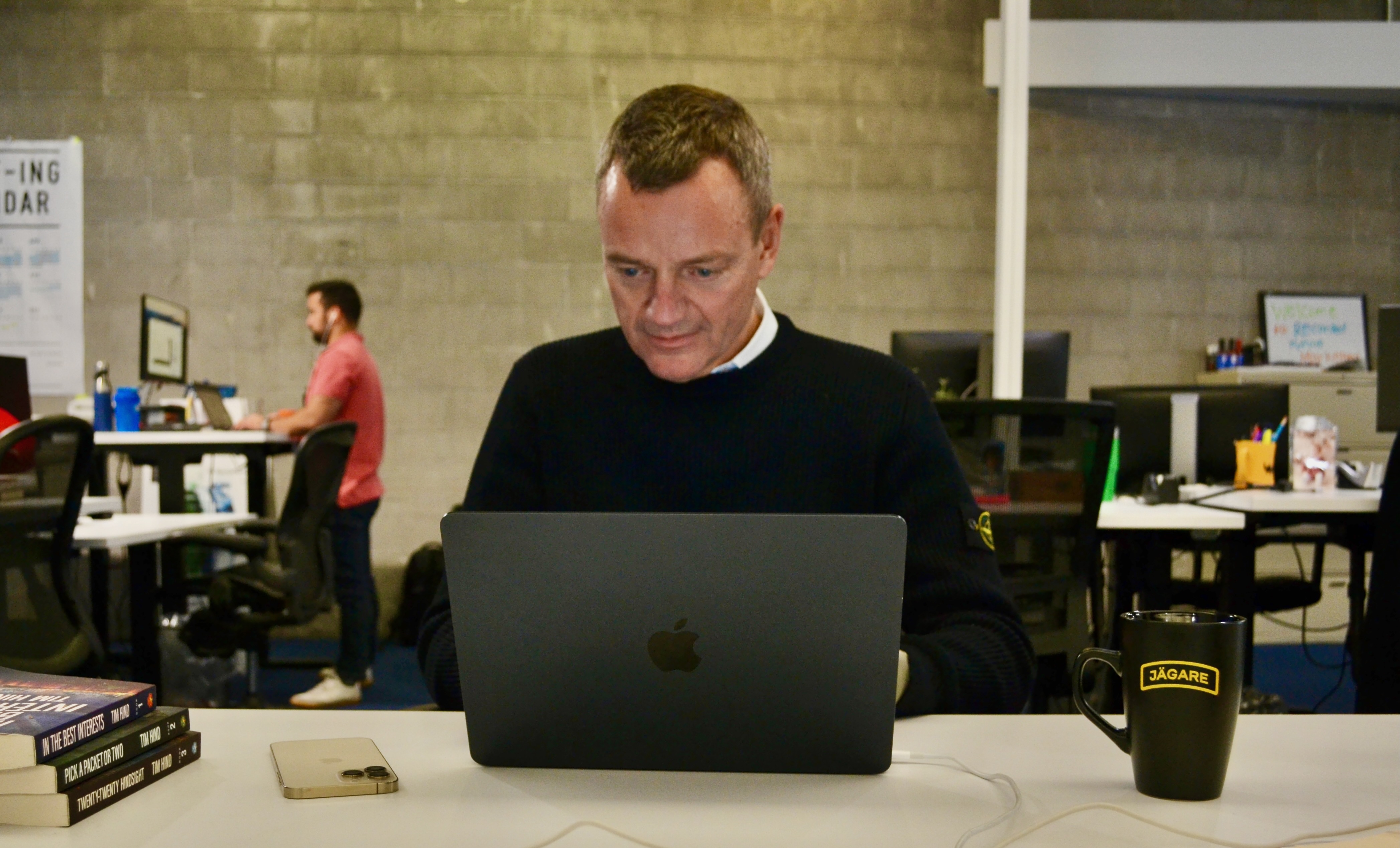 Christopher Ahlberg stands at a laptop in the Recorded Future office. 