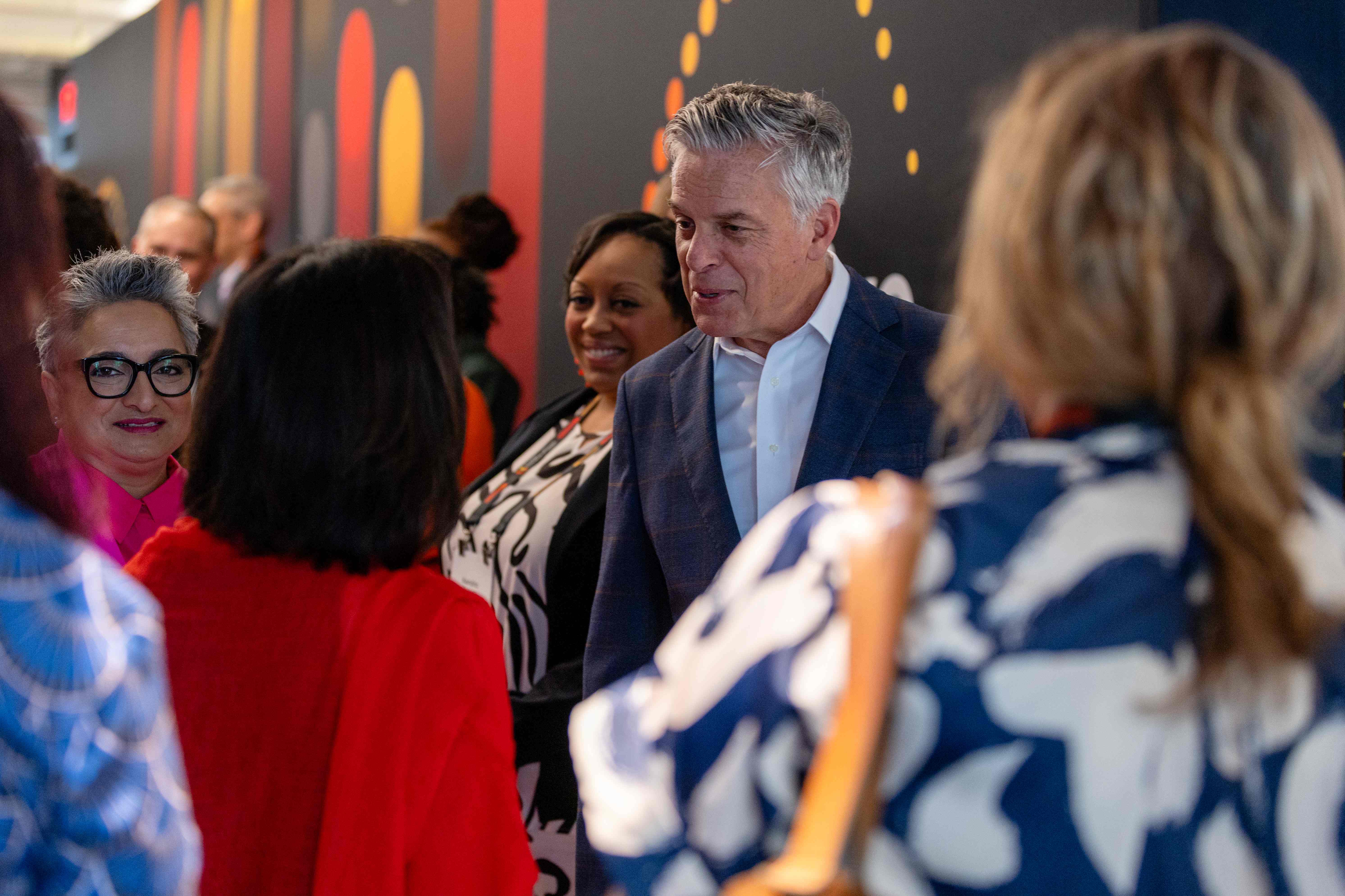 Shamina Singh and Jon Huntsman speak to attendees at the Global Inclusive Growth Summit in 2024.